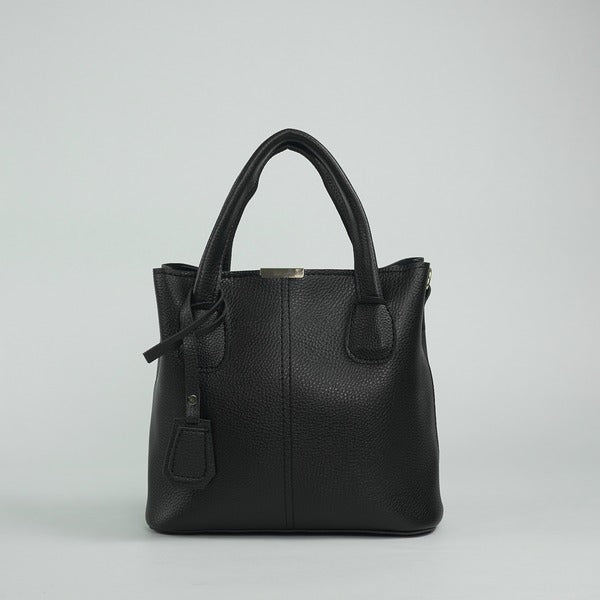 Black leather handbag with top handles, front detail, and hanging charm