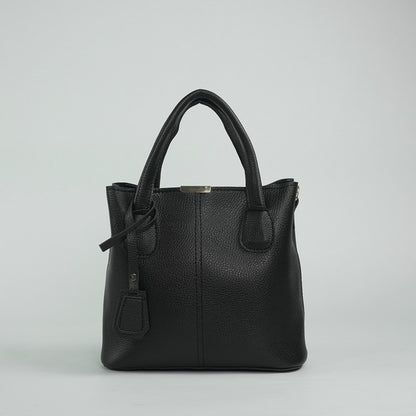 Black leather handbag with top handles, front detail, and hanging charm