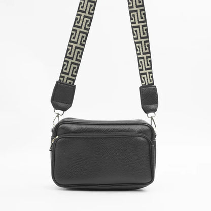 Black shoulder bag with top zip and adjustable Greek-key strap