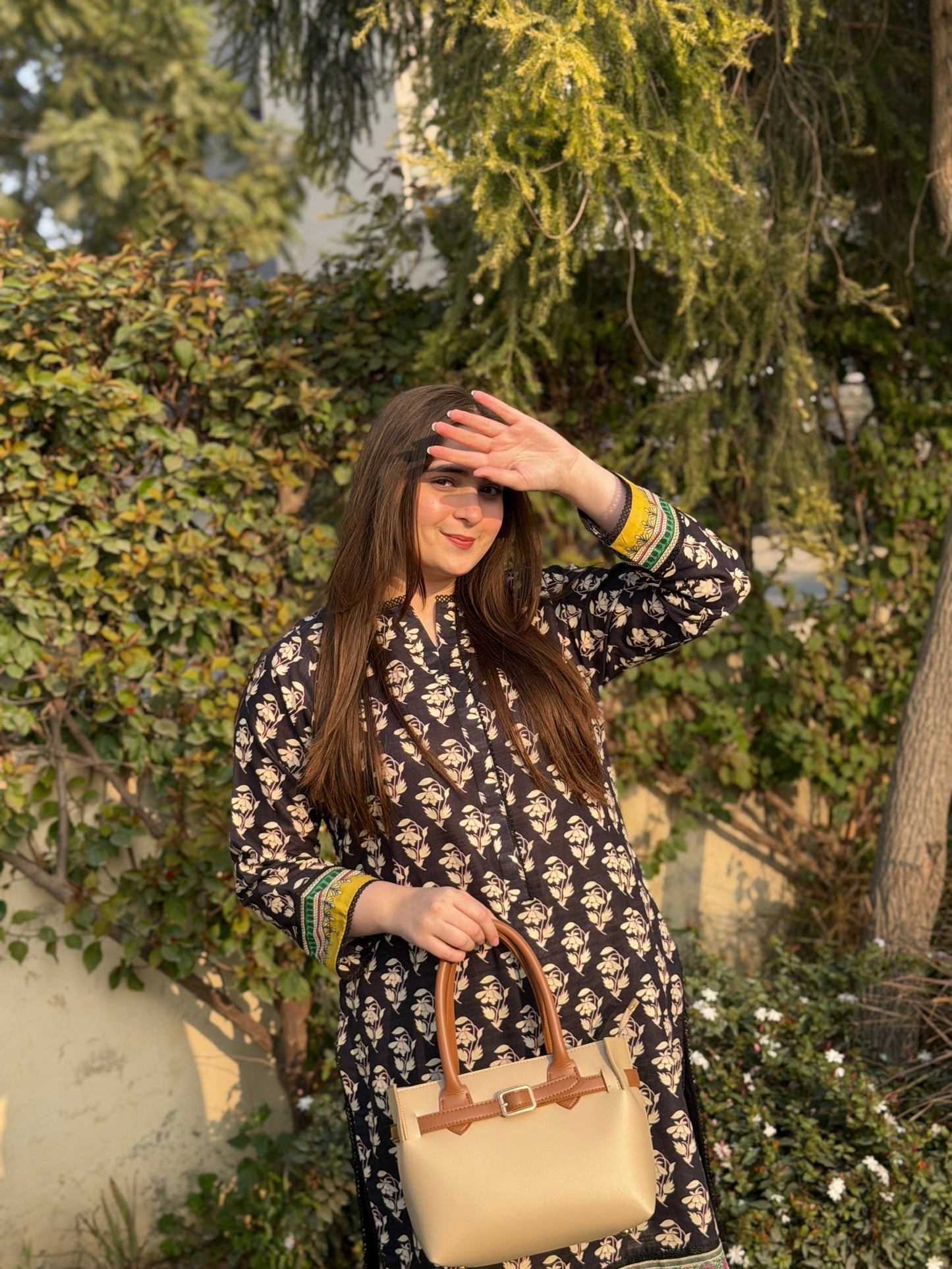Woman wearing beige tote bag set with buckle strap and detachable mini pouch