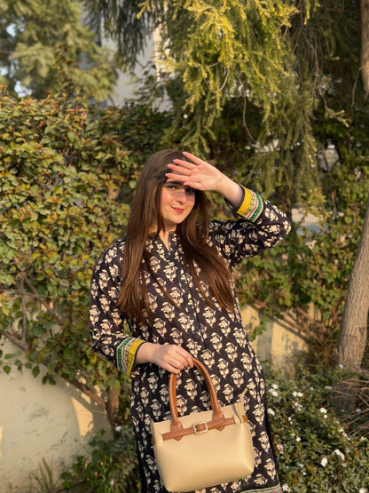 Woman wearing beige tote bag set with buckle strap and detachable mini pouch