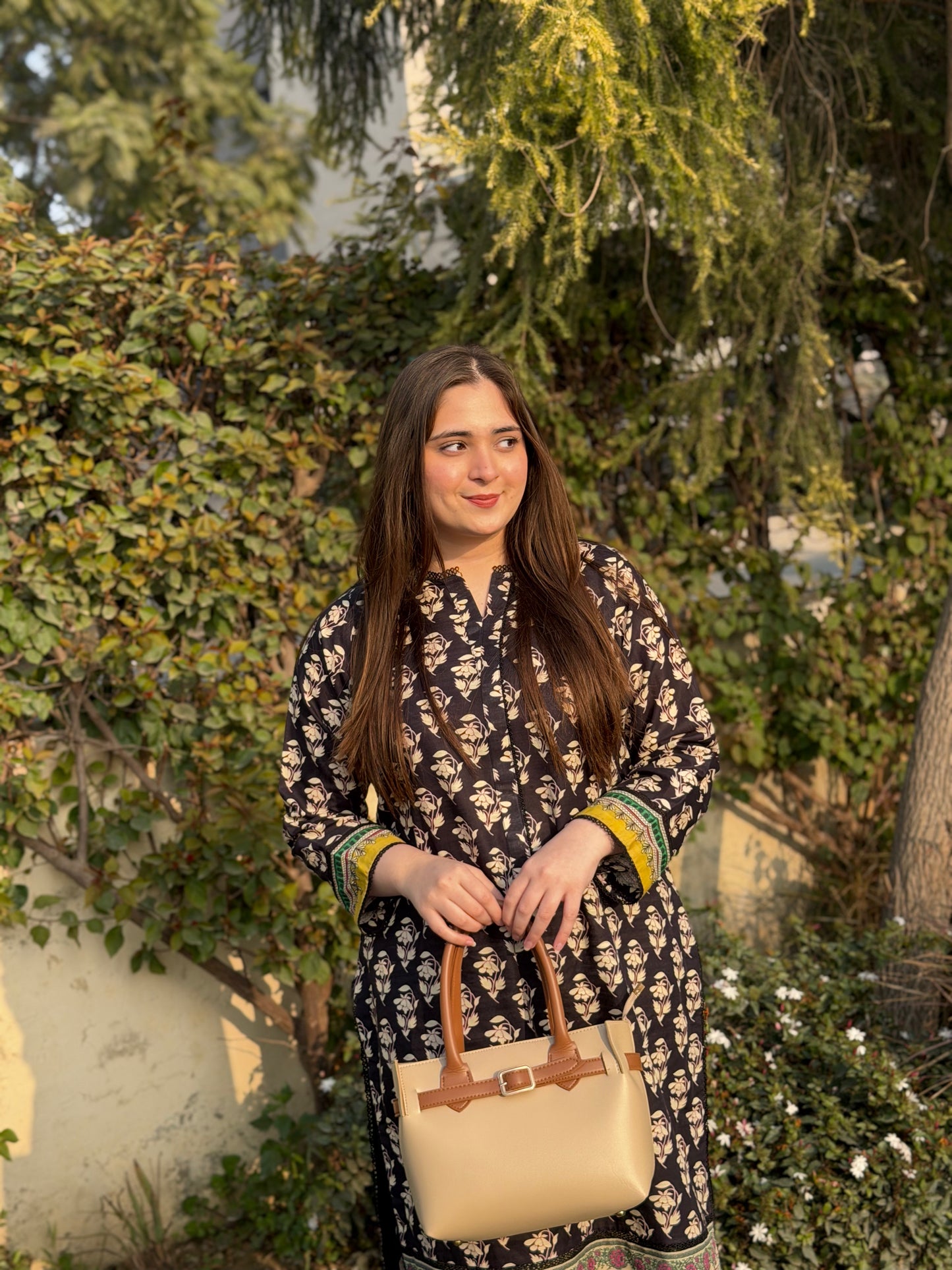 Woman carrying beige tote bag set with buckle strap and front flap pocket
