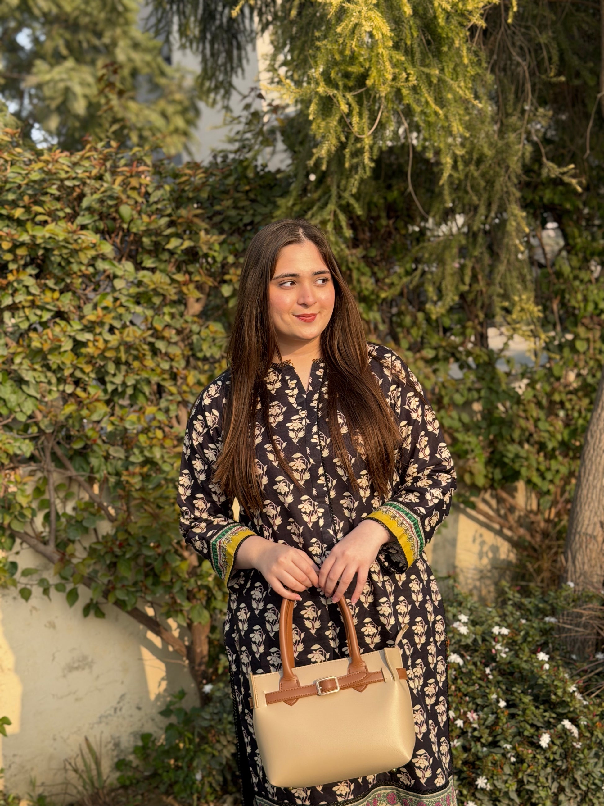 Woman carrying beige tote bag set with buckle strap and front flap pocket