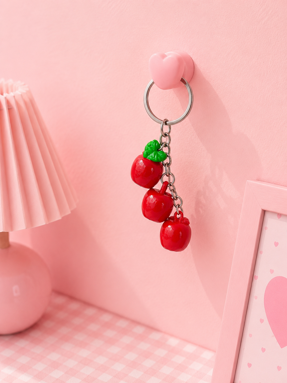 Glossy triple apple keychain with silver ring and pink heart charm, red apples and green leaf