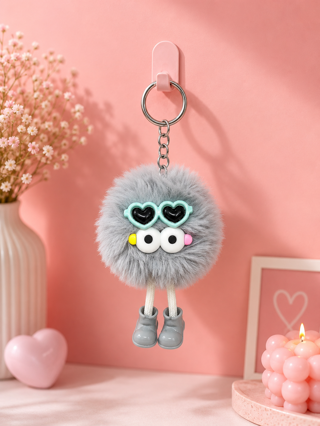 Gray fuzzy bear keychain with heart-eye charms, silver ring and small shoe dangles