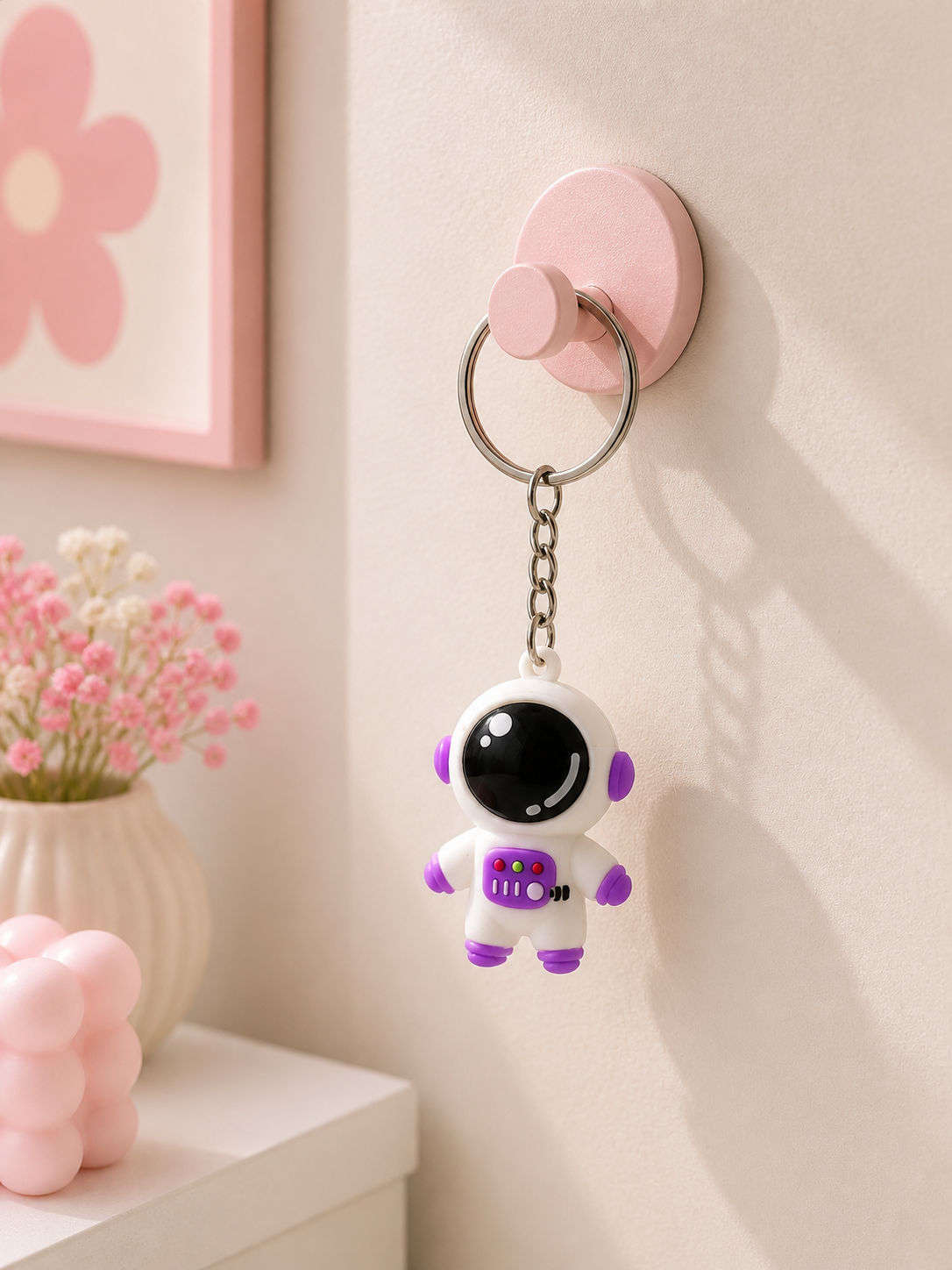 Purple astronaut keychain with black visor, metal ring and chain, hanging charm