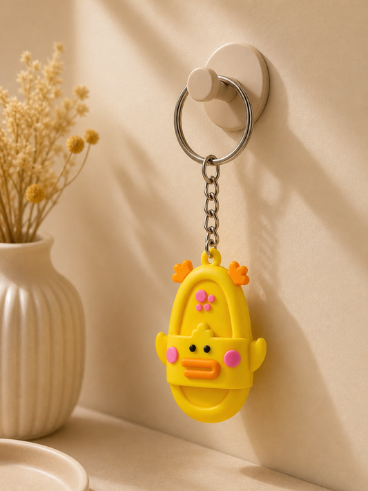 Yellow duck slide keychain with metal ring and chain, smiling face with pink accents