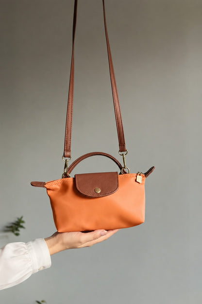 Brown crossbody bag with long adjustable strap and snap front flap pocket