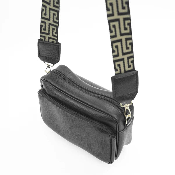 Black shoulder bag, side view, with two zip compartments and Greek-key strap