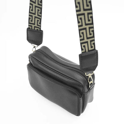 Black shoulder bag, side view, with two zip compartments and Greek-key strap