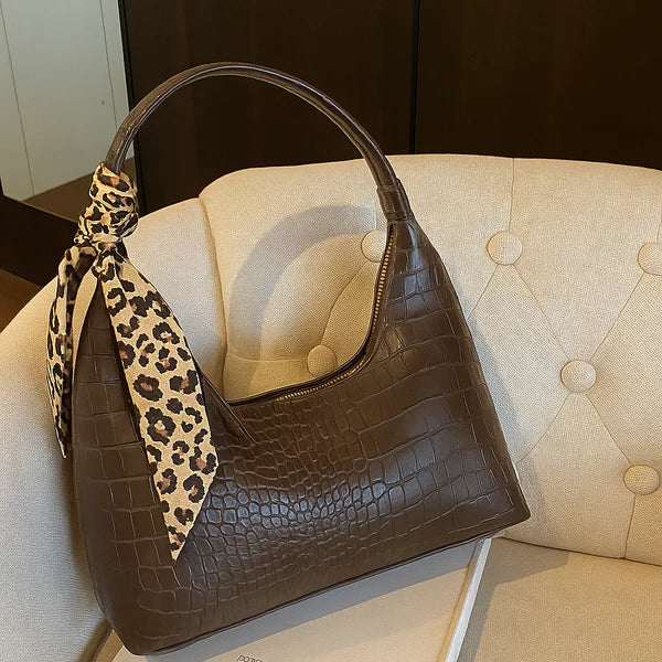Brown croc-effect shoulder bag with leopard print strap and top zip pocket