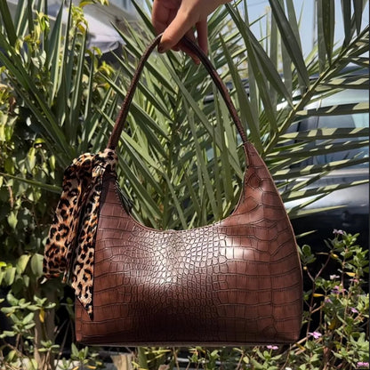 Brown croc-embossed hobo shoulder bag with long top handles and leopard-print tie
